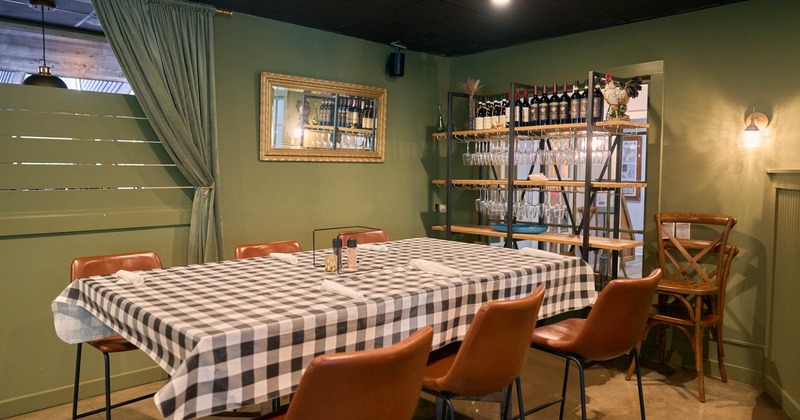 Interior, private area with wine bottles in the back