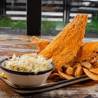 Fried catfish with potato chips and coleslaw.