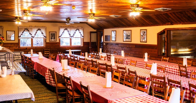 Celebration room with three rows of several tables joined together in a row