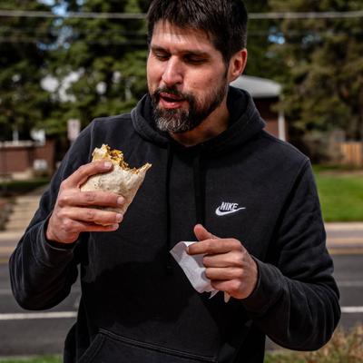 Customer eating a burrito.