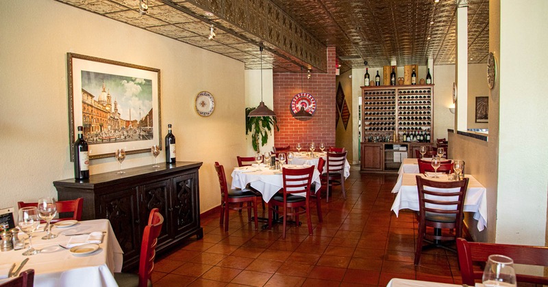 Interior, dining area, tables for four and two, vintage wooden cabinet, large format painting