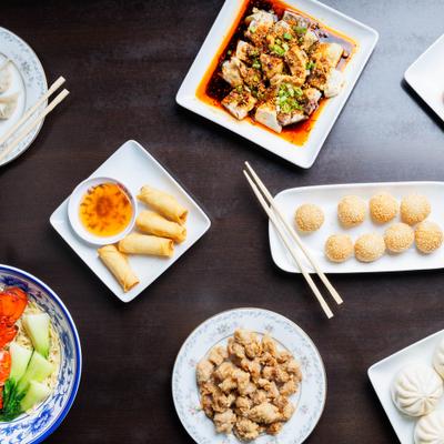 Assorted Asian dishes on a restaurant table.