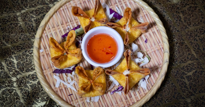 Crab Rangoon with house sweet sauce for dipping, top view