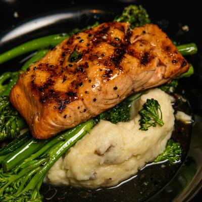 Honey Chipotle Salmon served over mashed potatoes and asparagus.
