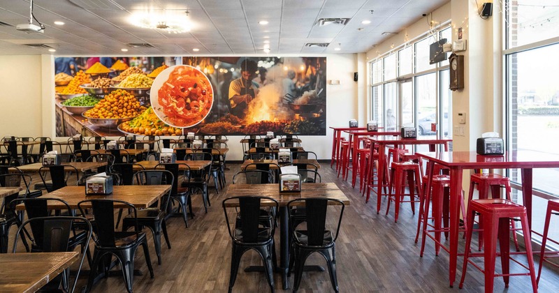 View of a dining area, tall tables on the right