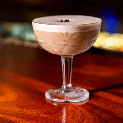 Creamy Espresso Martini on a wooden counter.