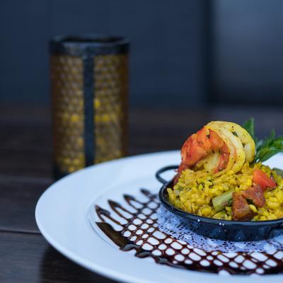 Plate with mini paella and candle.