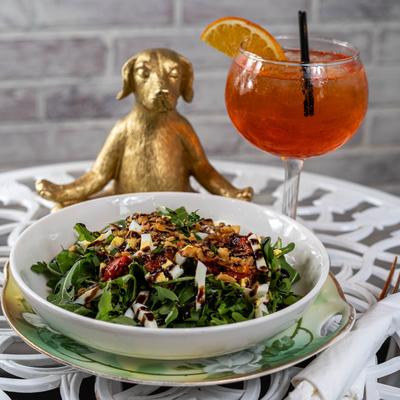 Arugula salad served with a cocktail drink.