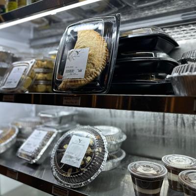 Packaged pies and desserts displayed in a refrigerated case.