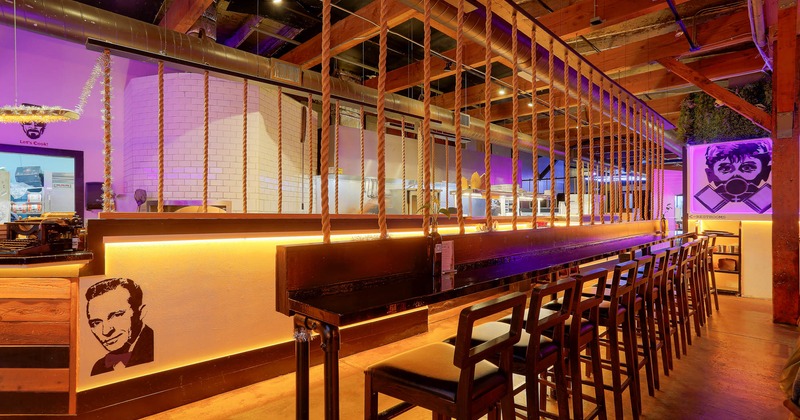 Interior, high seating area, bar with stools, rope decoration, exposed wooden beams