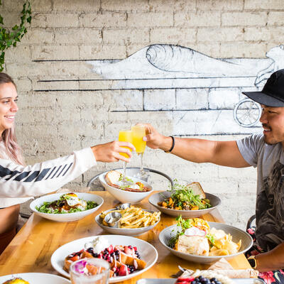 Two guests enjoying food and drinks