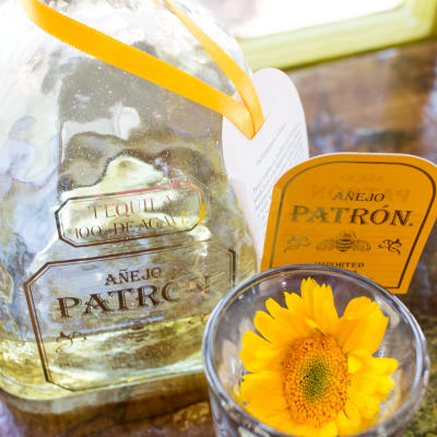 A tequila bottle and a flower.