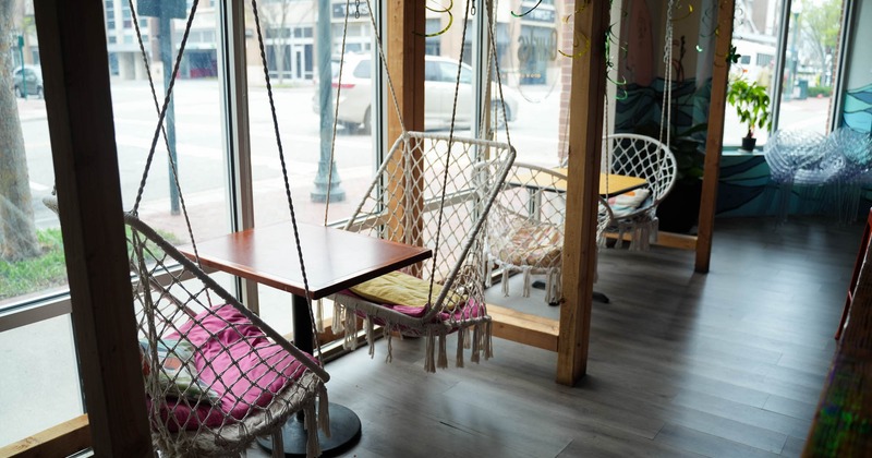 Interior, seating area with hanging chairs, other angle