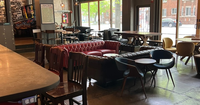 Cozy, industrial-style lounge seating area with leather sofas in the center