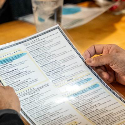 A person is holding a restaurant menu.