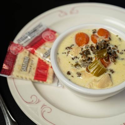 Bowl of Chicken Wild Rice Soup with crackers on the side.