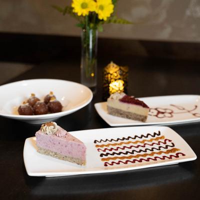 Raw, vegan cherry cheesecake served with additional desserts.