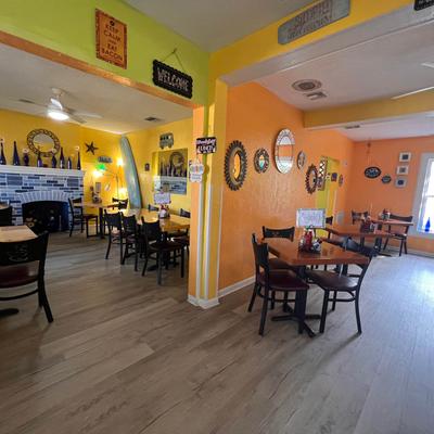 Interrior with colourful walls, tables, chaies and wall decorations.