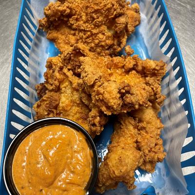 A basket of Korean-style fried chicken served with spicy mayo.