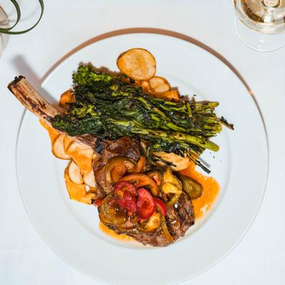 Tomahawk veal chop with broccoli rabe and potatoes.