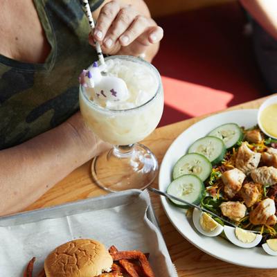 Honey Mustard Chicken salad, with mixed greens, egg, tomatoes, cucumber, tomato, and a cocktail.