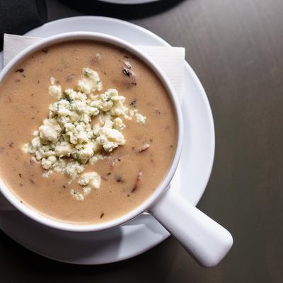 Cream of mushroom soup topped with crumbled cheese.