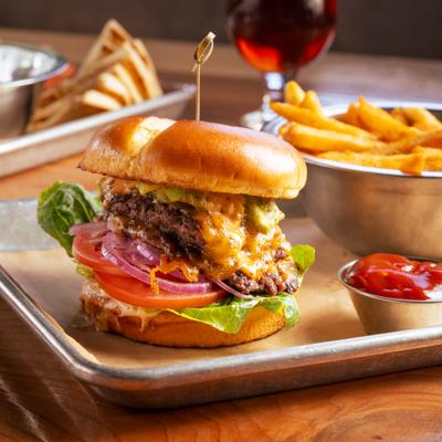 Cali classic cheeseburger with fries and ketchup.