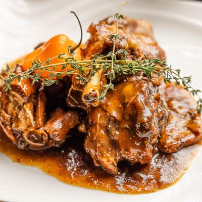 Oxtail stew garnished with spring of thyme.