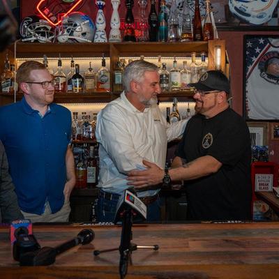 Governor Eric Holcomb with owner Rob Strong after the Governor signed HB1086 bringing Happy Hour back to the state of Indiana