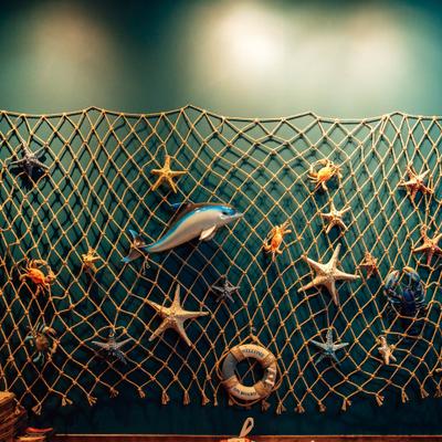 Fishing net with small marine ornaments.
