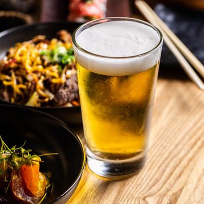 Glass of beer on a wooden table.