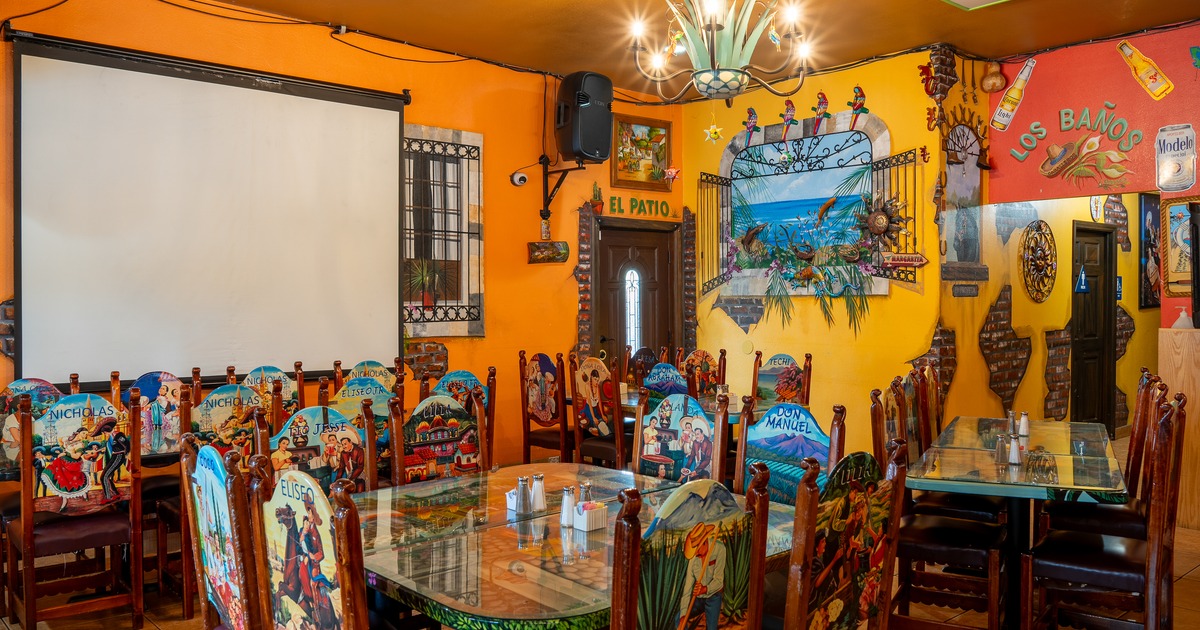 Diner tables, chairs, video screen above