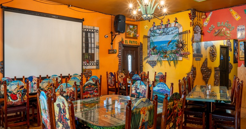 Diner tables, chairs, video screen above