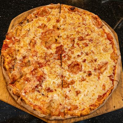 Cheese pizza on a wooden board.