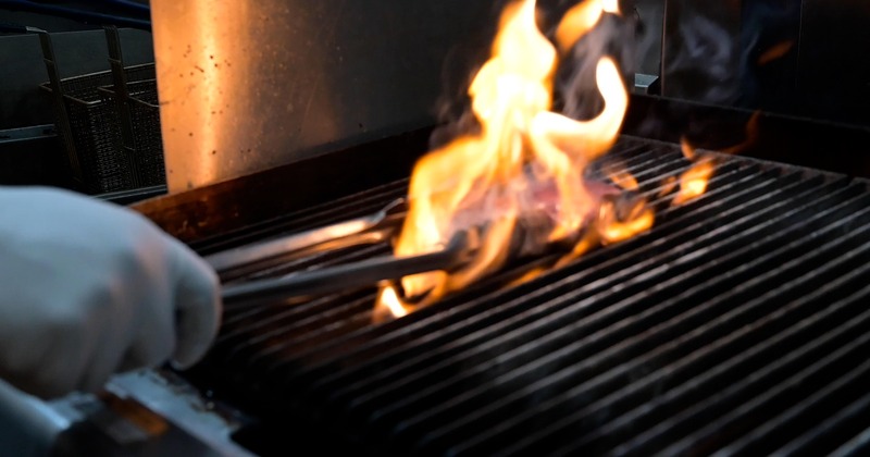 Large space, bar with bar stools, and tables and chairs along the wall