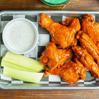 Buffalo chicken wings served with celery and a dipping sauce.