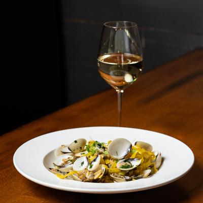 Linguine Clams served with a glass of white wine.