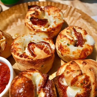 Pizza knots with a side of marinara sauce.