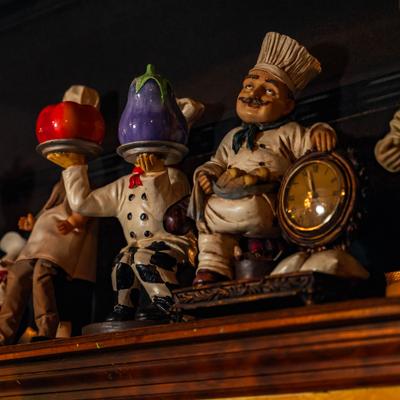 Decorative figurines of chefs in various poses.