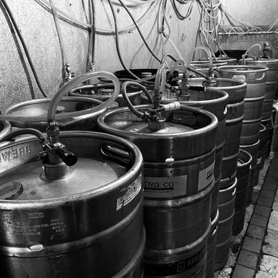 Rowes of 1/2 barrel kegs hooked up in Keg cooler.