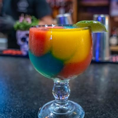 Colorful cocktail on a counter.
