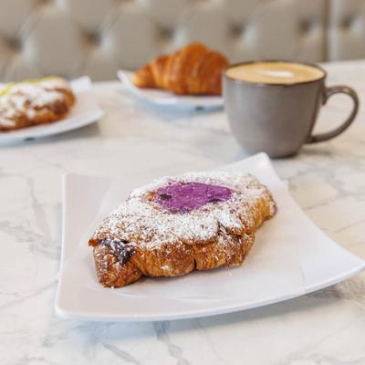 Ube croissant served with coffee.