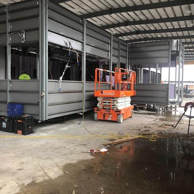 A building space with a scissor lift in the middle of it