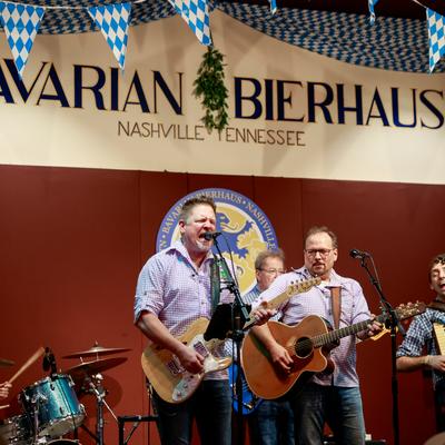 Interior, a band performing on the stage.