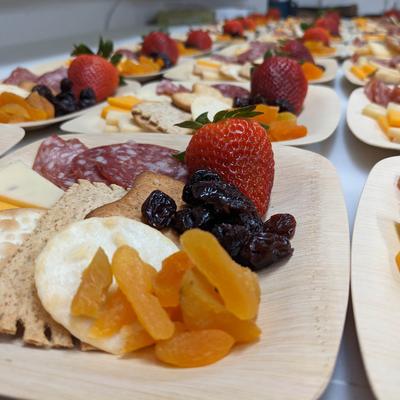 Sausage, crackers, cheeses, and mixed fruits