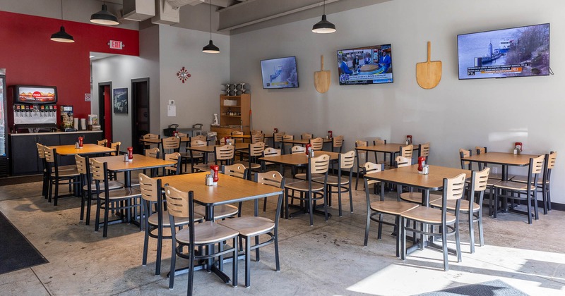 Restaurant interior, main seating area with big TVs on the wall