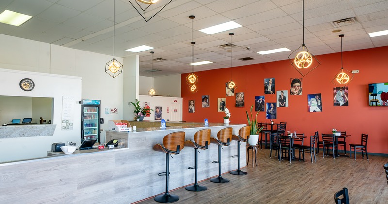 Spacious and cozy restaurant interior with long bar and seating area