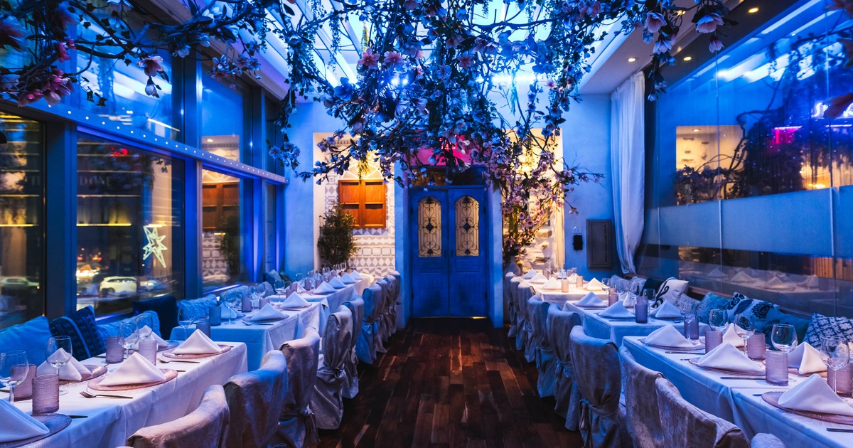 Dining room with blue lighting and hanging flowers