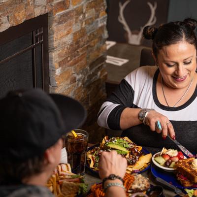 People dining together, sharing meals at a restaurant table.