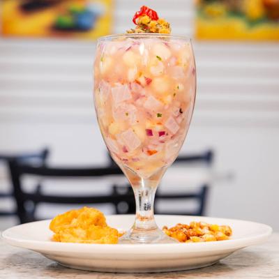 Peruvian ceviche served in a goblet glass.